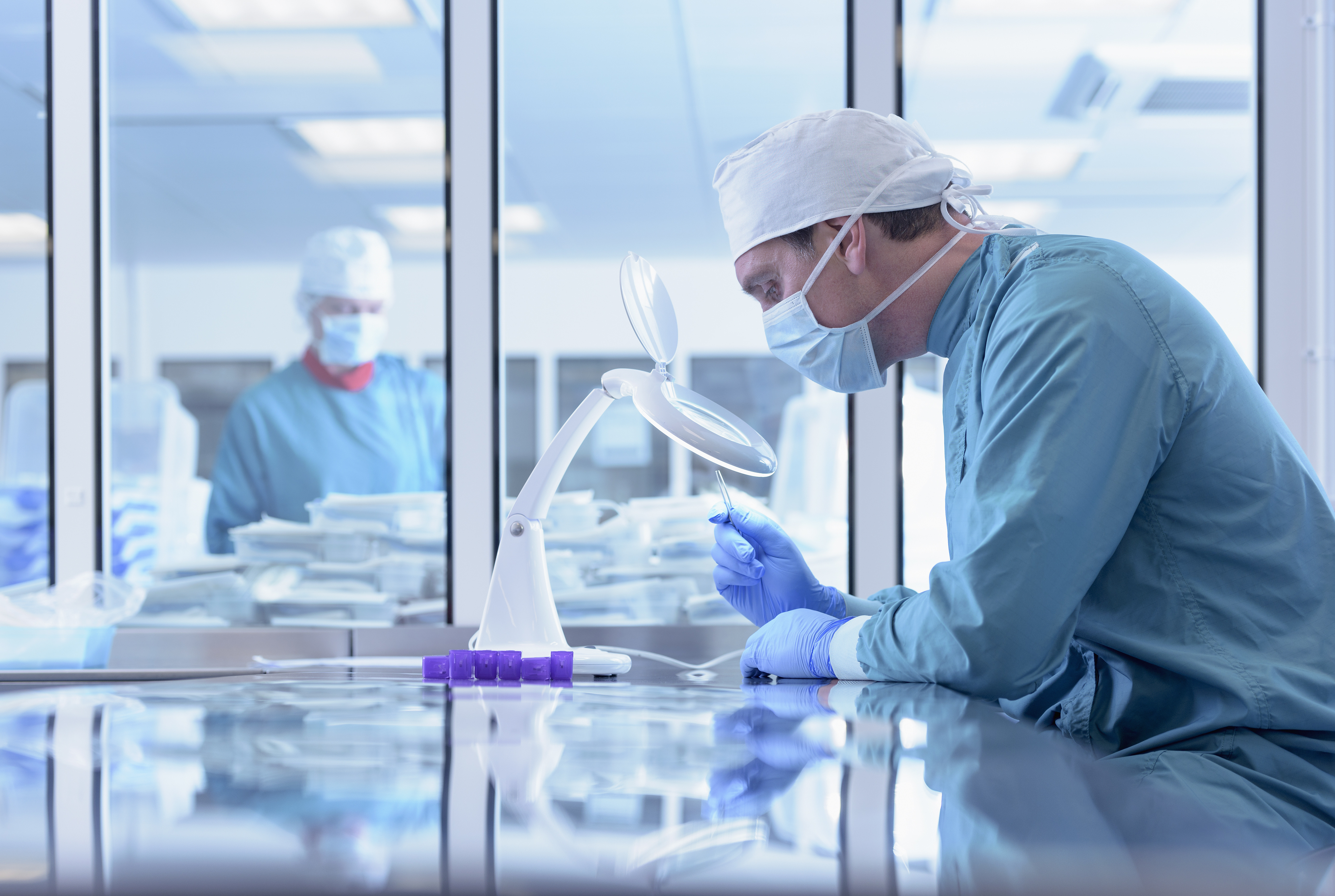 Workers inspecting surgical instruments in clean room of surgical instruments factory